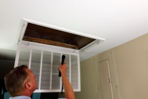 Homeowner doing a home ventilation inspection