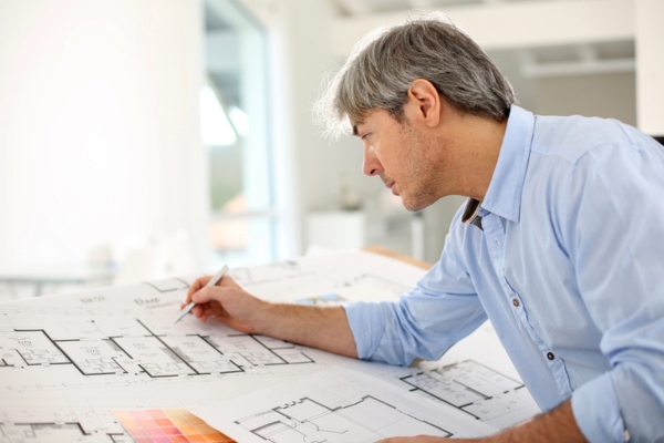 architect working a blueprint of a house