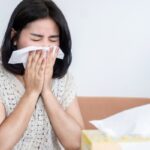 homeowner feeling sick with tissue on nose depicting poor indoor air quality