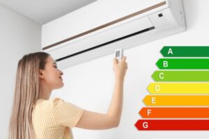 woman turning on ductless air conditioner with energy efficiency meter