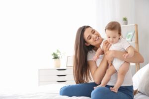 mother and baby lounging at home depicting good indoor air quality