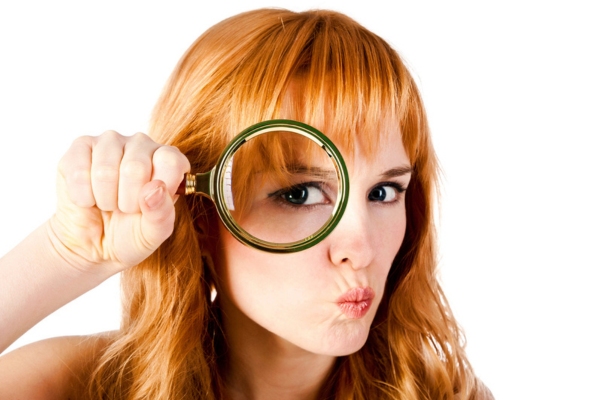 woman with magnifying glass depicting identifying AC problems