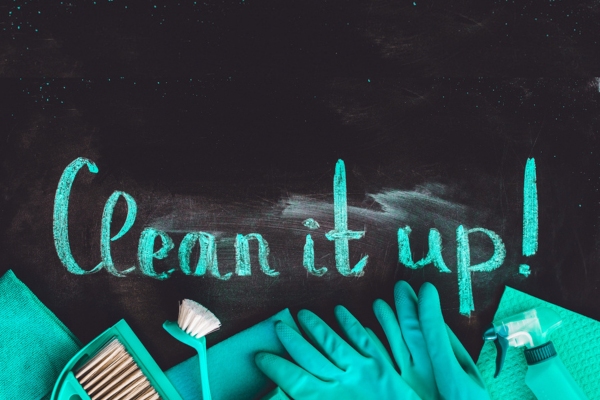 clean it up word written on chalkboard with cleaning materials below depicting cleaning furnace area