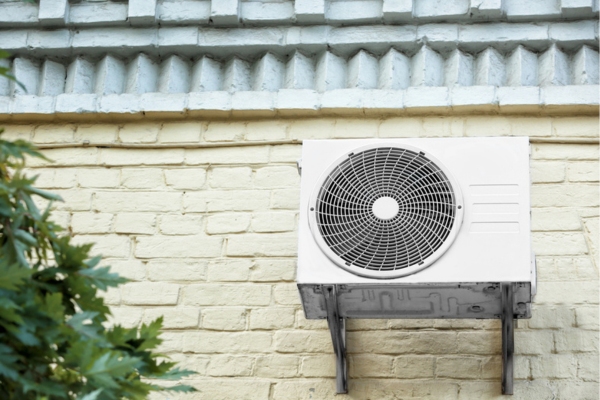 image of an elevated heat pump installed on the side of the house