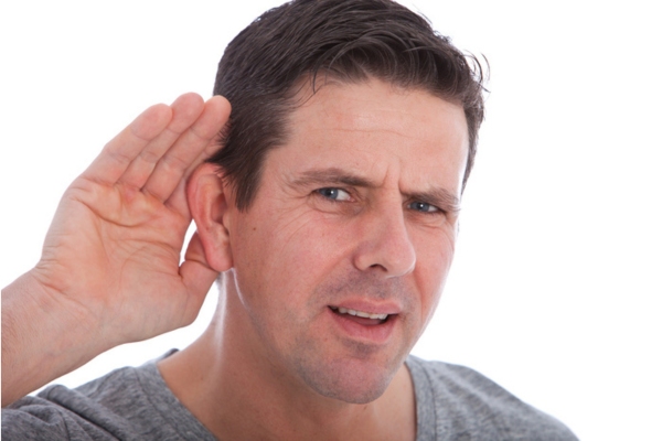 man cupping his right ear trying to listen to furnace sounds