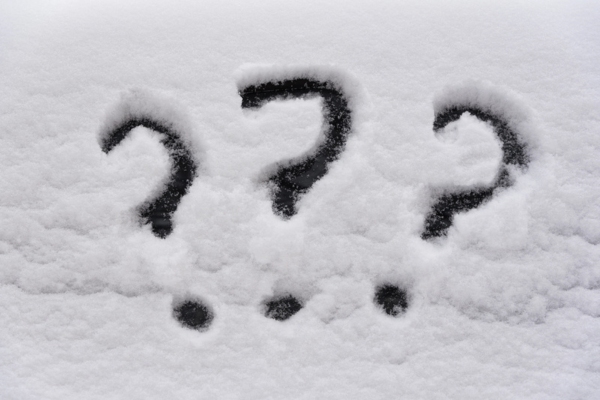 question marks doodled on a snow surface depicting FAQs about furnace sounds