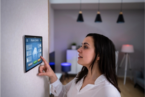 woman controlling thermostat using smart HVAC home control