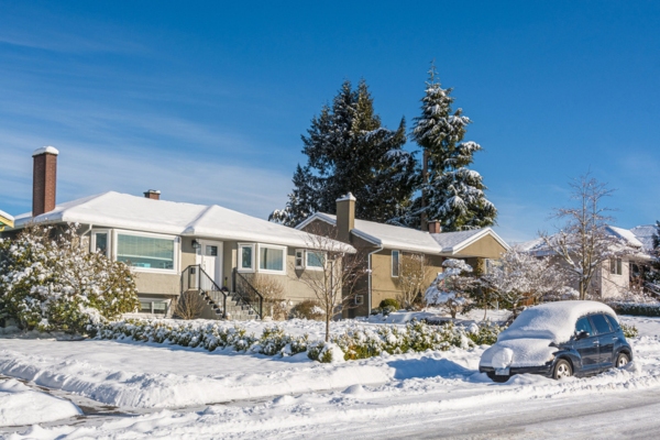 snow covered residential house and car depicting seasonal patterns